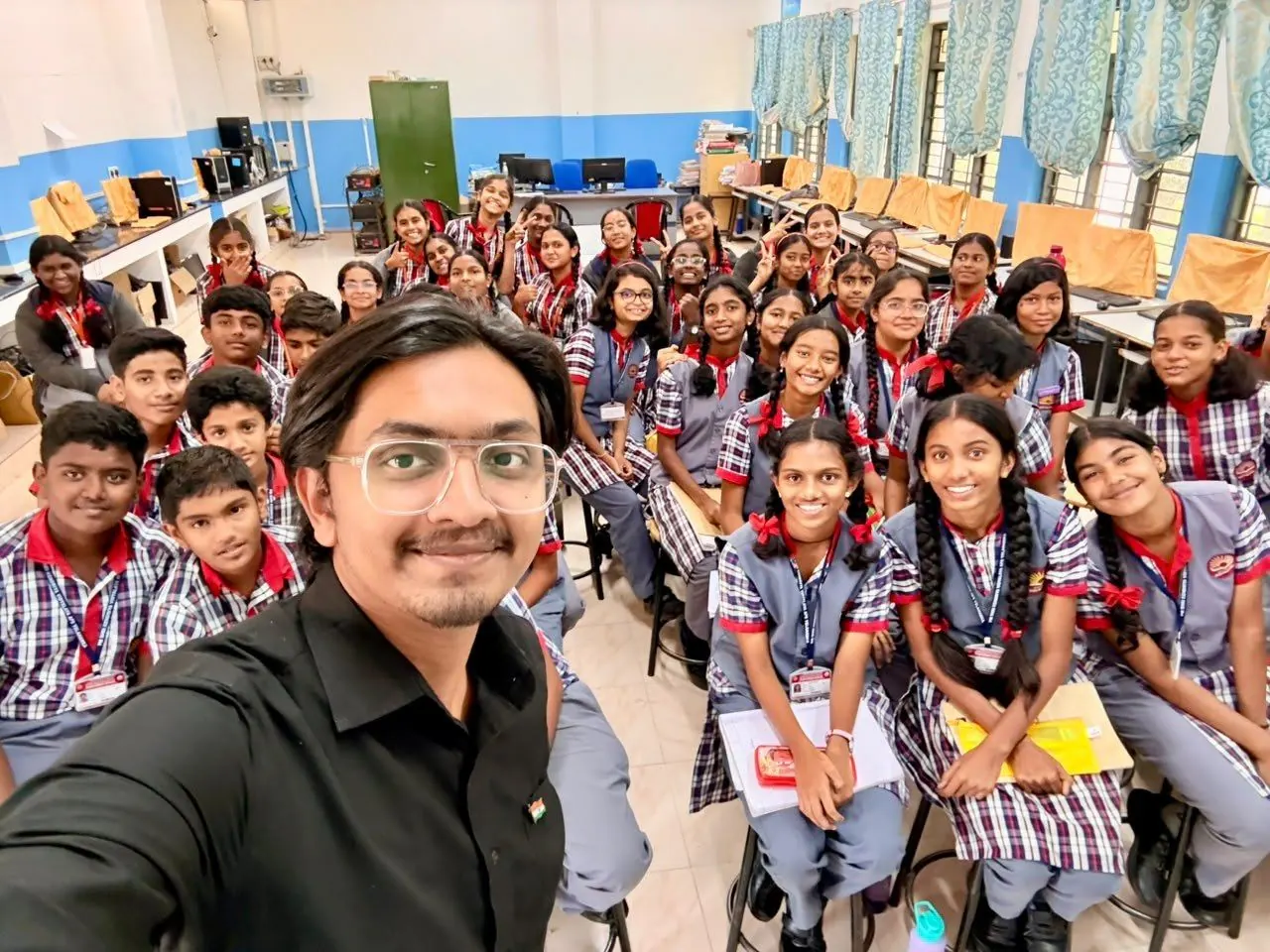 Kabeer with students after a DOT classroom session